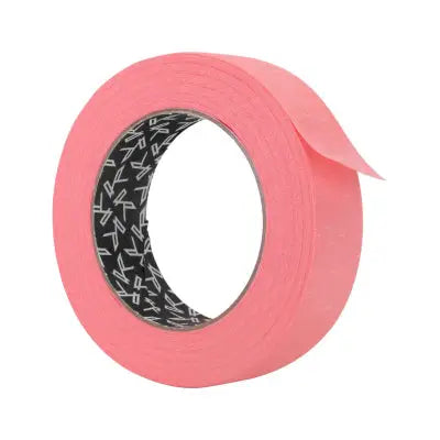 A roll of bright pink killer ink paper tape with a black and white patterned inner core for painting tasks