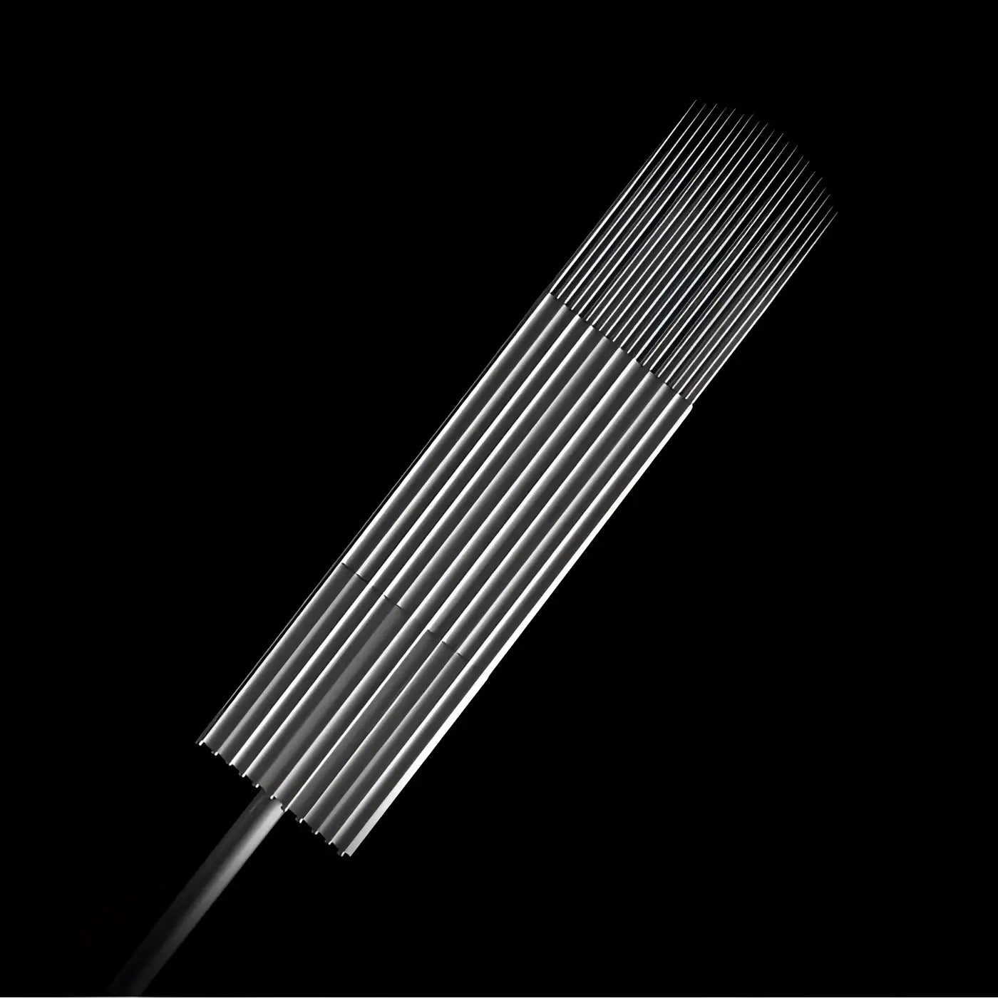 A set of sleek metallic large shader curved magnum tattoo needles from killer ink arranged in a row on black background