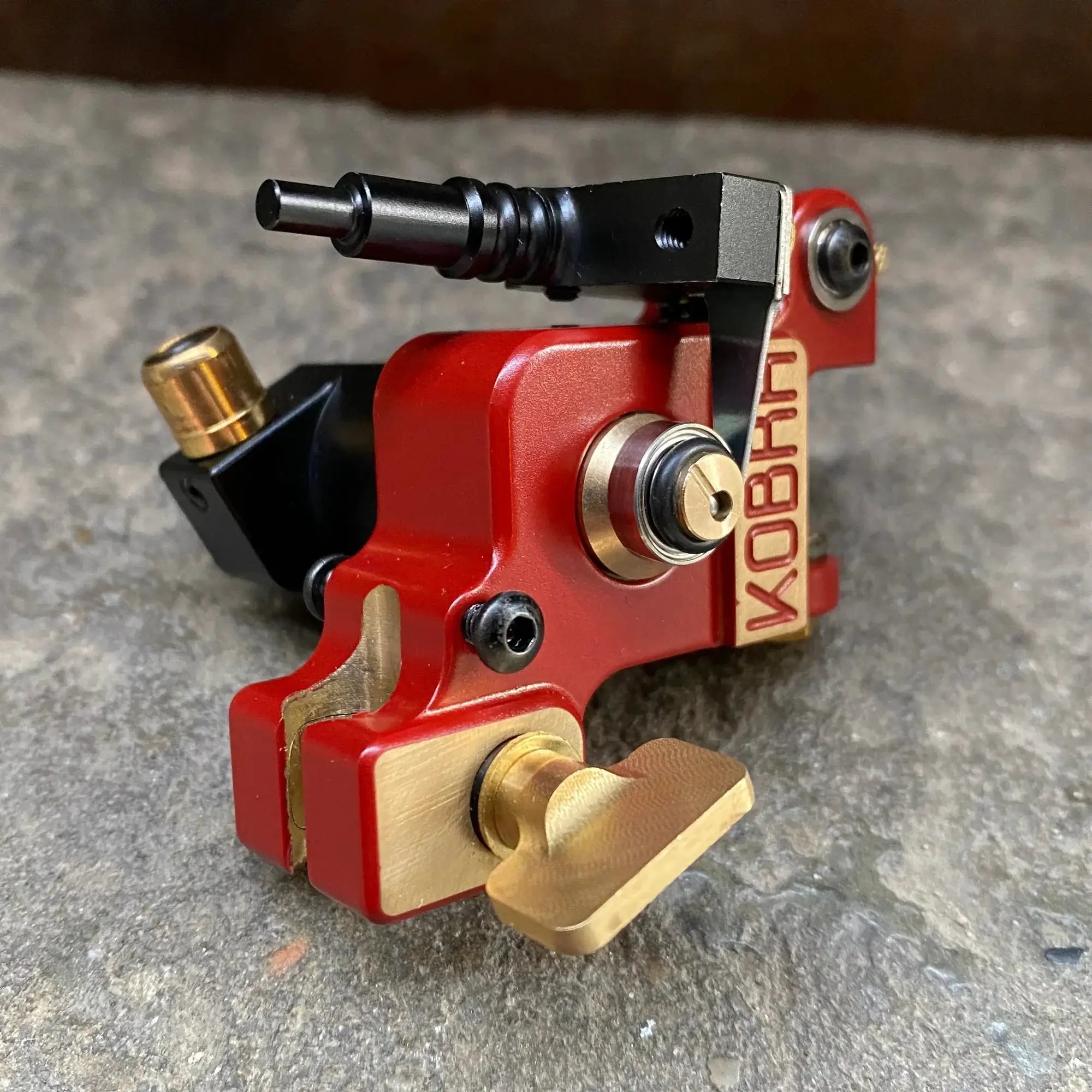 Kobani liner 02r burgundy tattoo machine in red and gold with black accents for precise tattooing