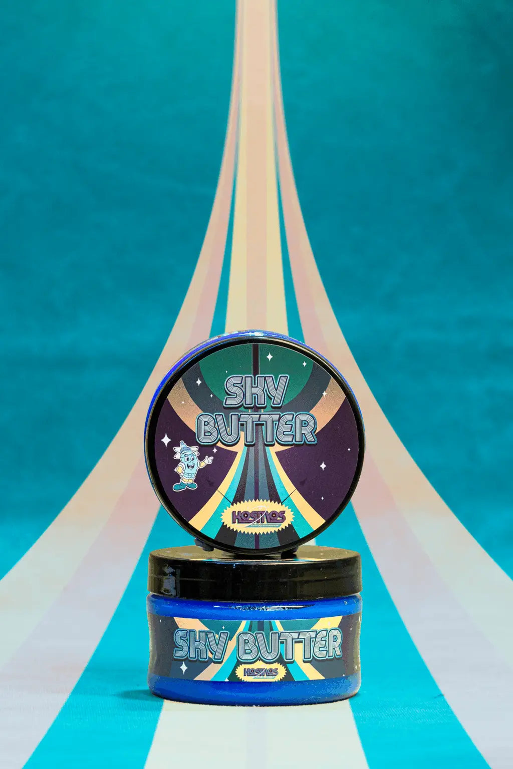 Blue cylindrical container of shy butter hair butter with black lid and colorful space themed kosmos sky butter label