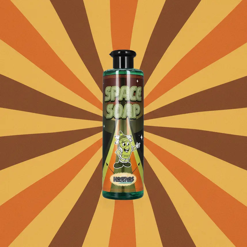 Green translucent bottle of kosmos space soap with a cartoon astronaut character and black cap