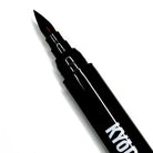 Black Kyocera Kyodai firm-tip brush pen with fine pointed tip and metallic accents for precise writing and drawing