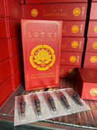 Red lotus cartridges box with gold foil lotus emblem containing five black curved magnum tattoo needles in clear plastic packaging