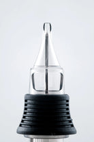 NEXUS round shader cartridge with clear glass needle tip and black textured grip for precision tattooing
