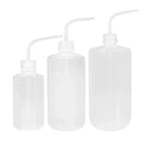 Three translucent transparent plastic rinse wash squeeze bottles with curved spouts in small to large sizes