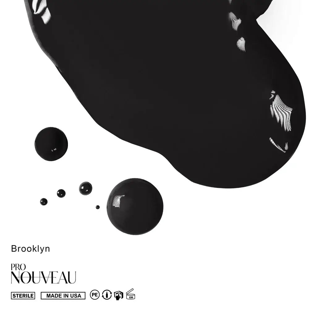 Black nail polish in a sleek modern bottle with silver winged logo accents from pro nouveau brows collection pmu pigment brooklyn