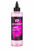 A clear plastic bottle with black cap contains pink vegan proton c cristal shading solution for panthera cristal shading