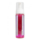 A clear plastic bottle with a white pump filled with vibrant pink foam numbing effect liquid from proton evolution pro line