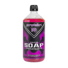 A vibrant pink proton evolution soap in a 1000ml transparent plastic bottle with numbing effect and black cap