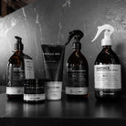 Set of tattoomed professional tattoo aftercare products in sleek dark glass and matte black containers with white labels