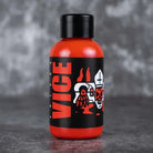 Vice burning red orange liquid bottle with black cap and skull graphic label for vaping use