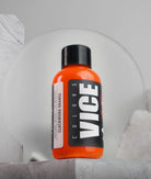Vice clockwork orange paint bottle with a glossy orange body and black cap for vibrant color projects