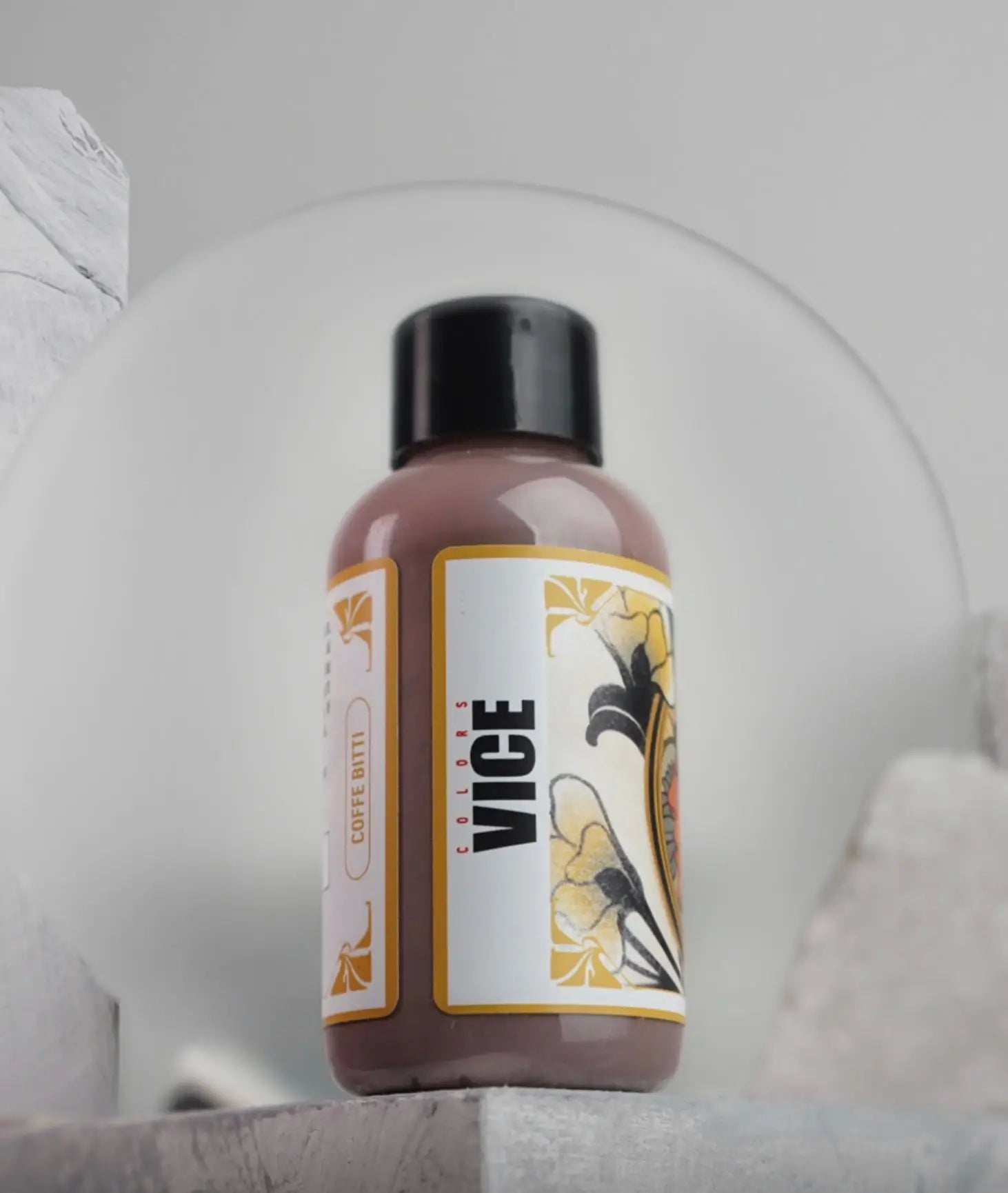 A matte brown plastic bottle with black cap and ornate label for vice colors coffee dye in the vice coffe bitti set