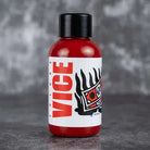 Red plastic bottle with black cap and white label featuring bold red vice text and stylized eye graphic for vice criminal red