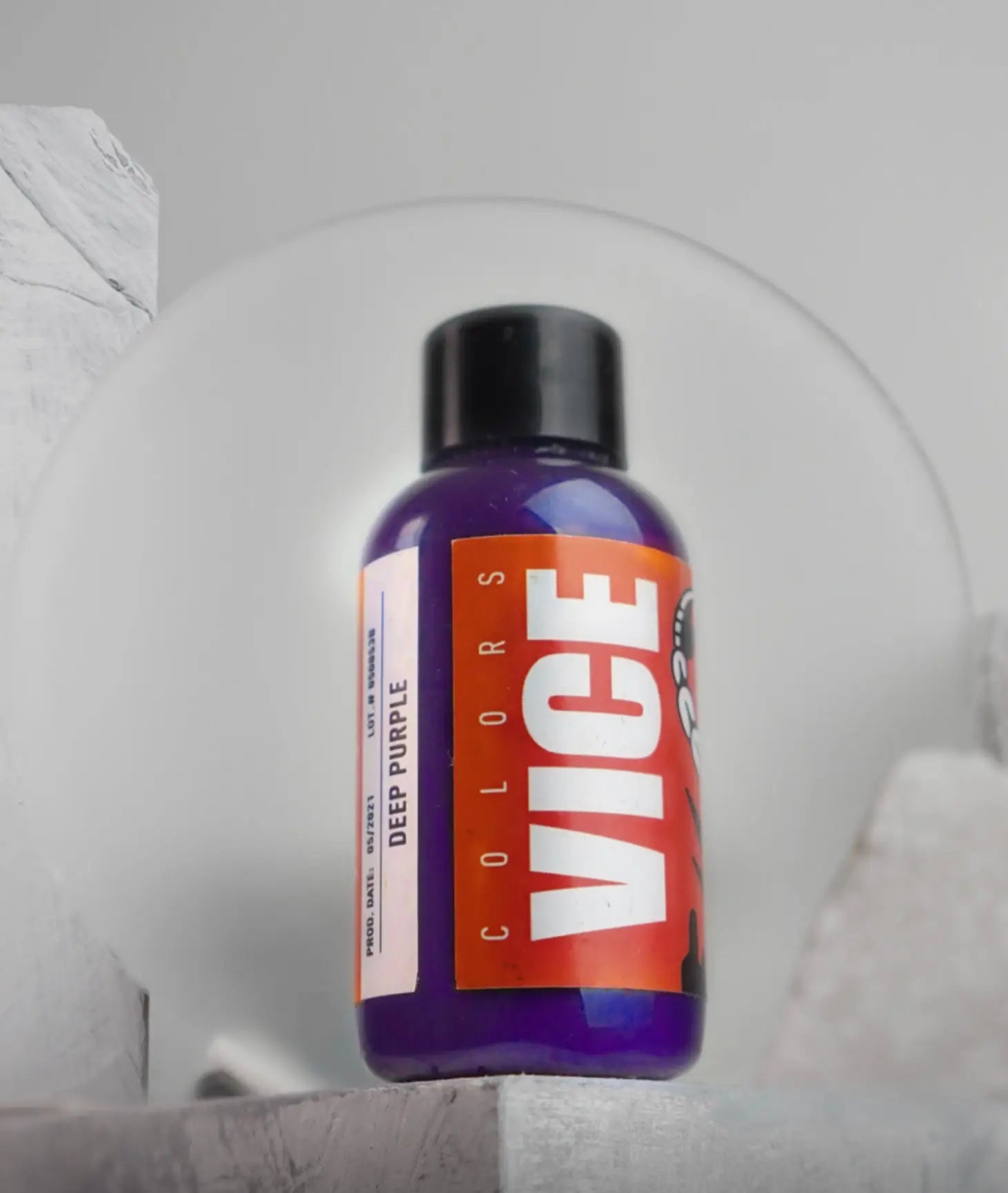 A vibrant purple bottle of vice colors deep purple hair dye with a black cap and bold orange label for hair coloring
