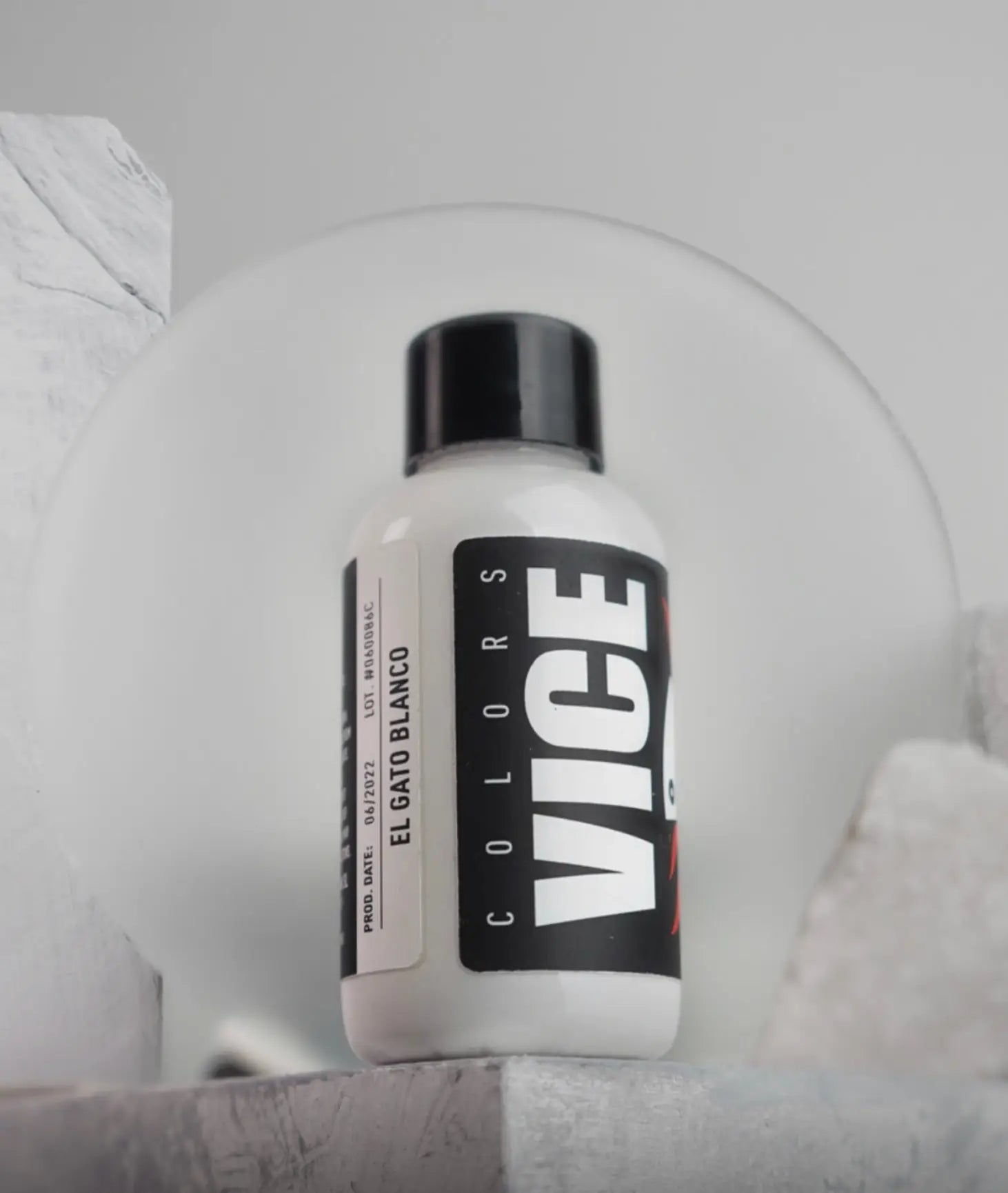 White plastic bottle with black cap featuring bold vice colors label and product name el gato blanco