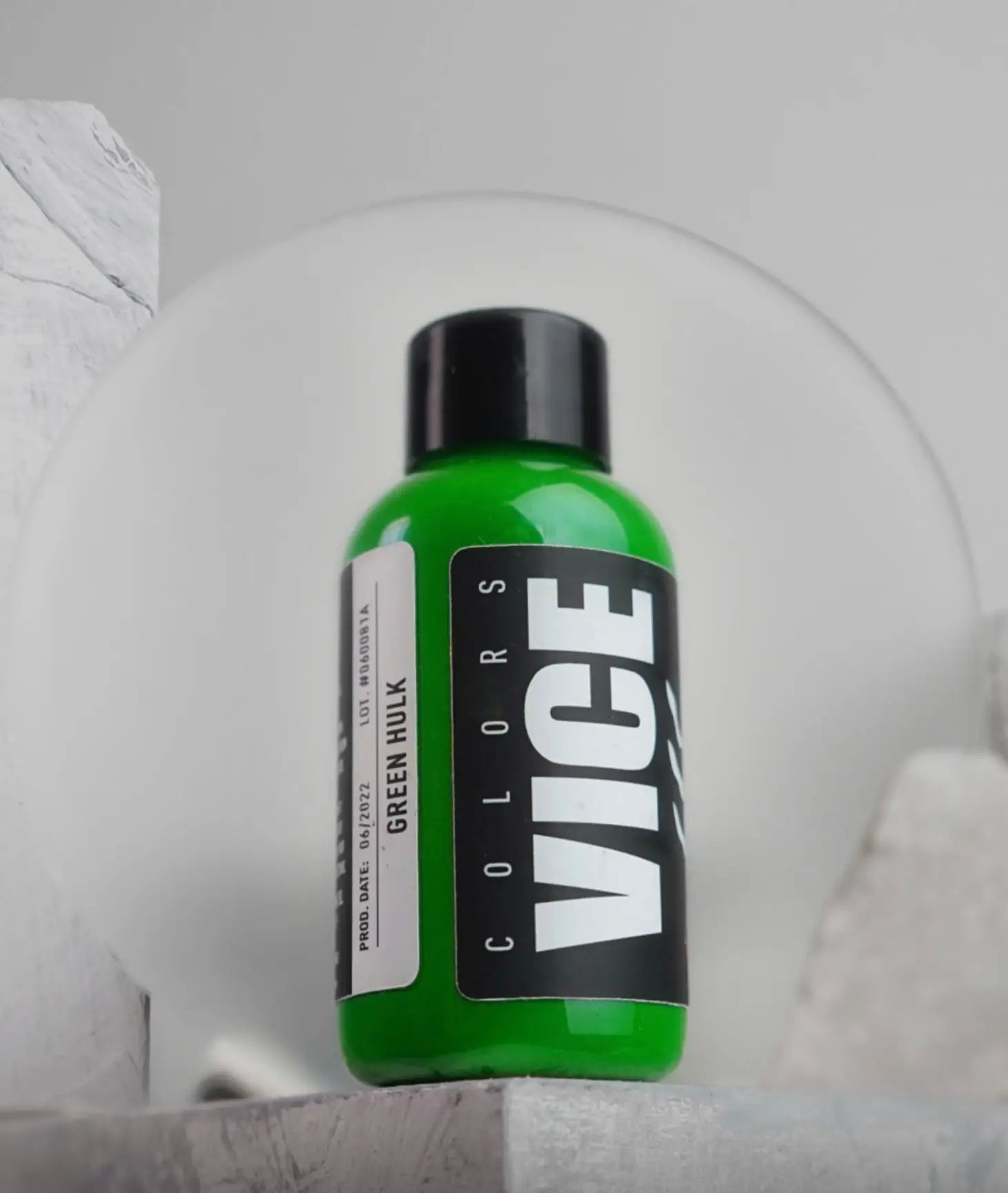 A vibrant green plastic bottle with a black cap labeled green hulk from VICE in bold white vice colors branding
