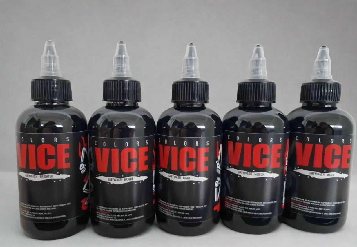 Five black plastic vice brand tattoo ink bottles with clear nozzles labeled in red from vice greywash set bundle