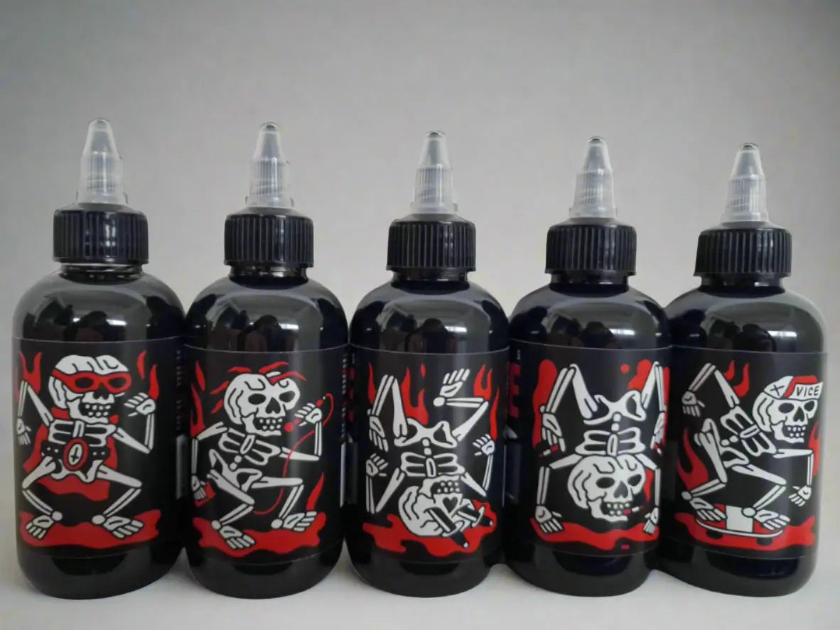 Five black plastic bottles with clear caps and red and white skeleton designs from vice greywash set bundle