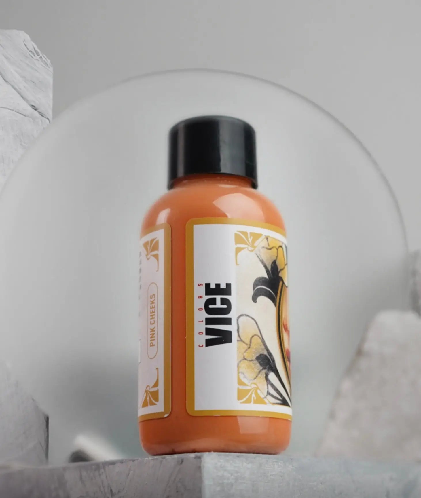 Orange vice pink creme bottle with black cap and floral label design from daniels bauti vice pink cheeks set