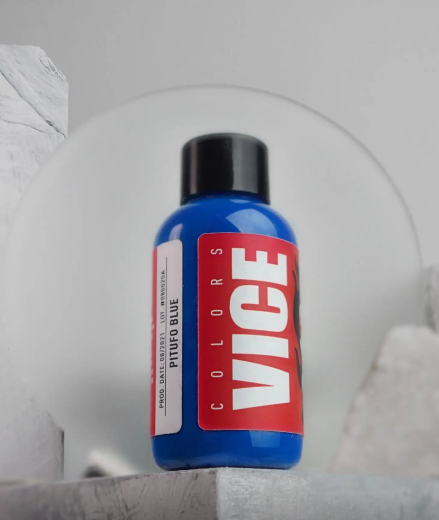 A vibrant blue vice colors paint bottle pitufo blue with a bold red label white lettering and a black cap