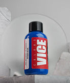 A vibrant blue vice colors paint bottle pitufo blue with a bold red label white lettering and a black cap