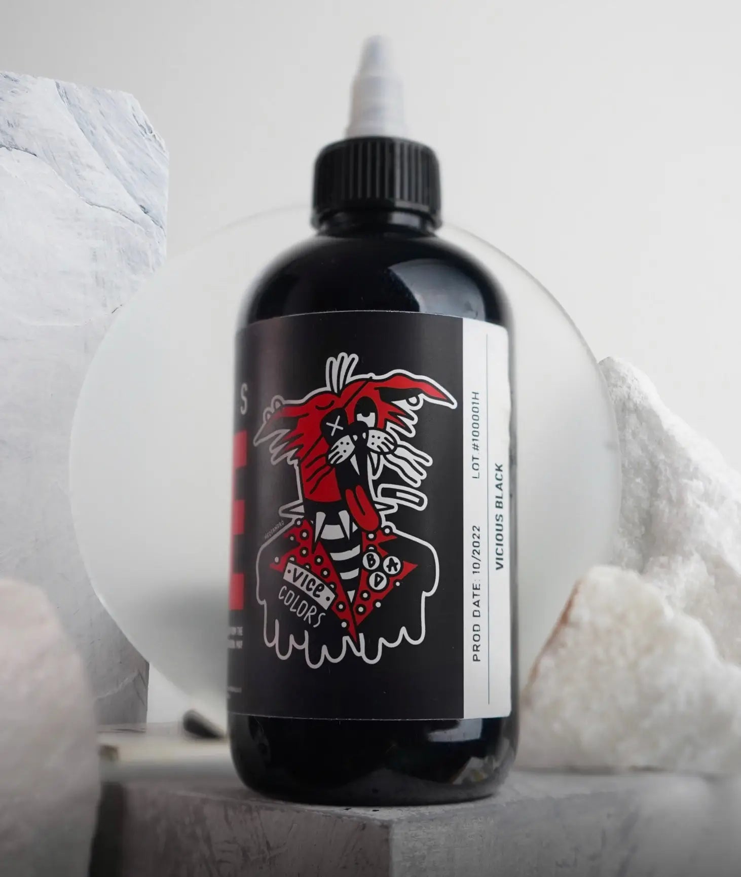 A sleek black bottle of Vice Colors tattoo ink with a bold red and white label marked vicious black shade