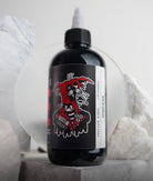 A sleek black bottle of Vice Colors tattoo ink with a bold red and white label marked vicious black shade