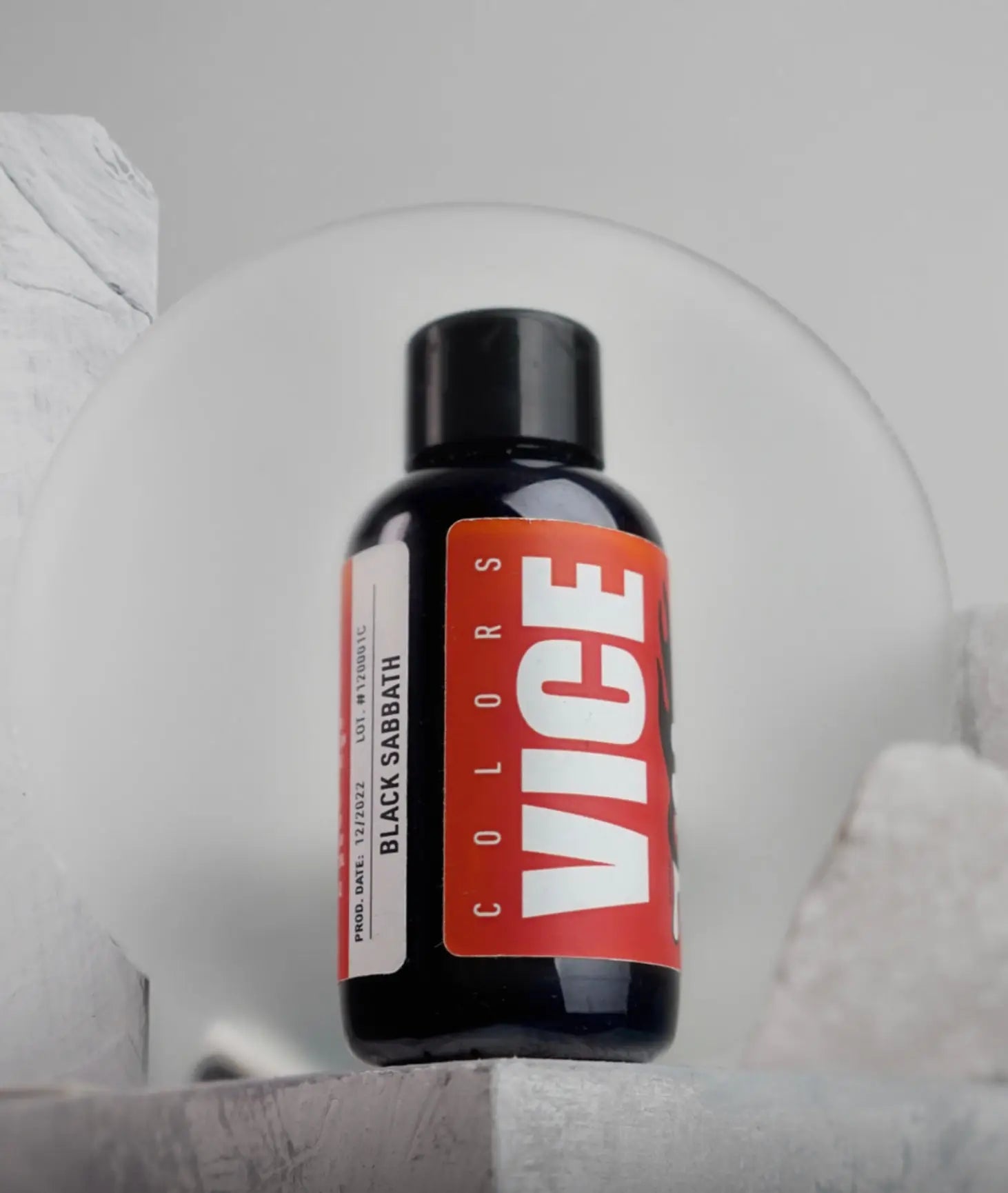 A sleek black bottle of vice colors black sabbath ink with a bold red label white lettering and a matte black cap