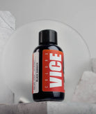 A sleek black bottle of vice colors black sabbath ink with a bold red label white lettering and a matte black cap