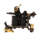 Schwarze und goldene VLAD BLAD Coil-Tätowiermaschine mit zwei zylindrischen Spulen und robustem industriellem Design in alter Petrolfarbe