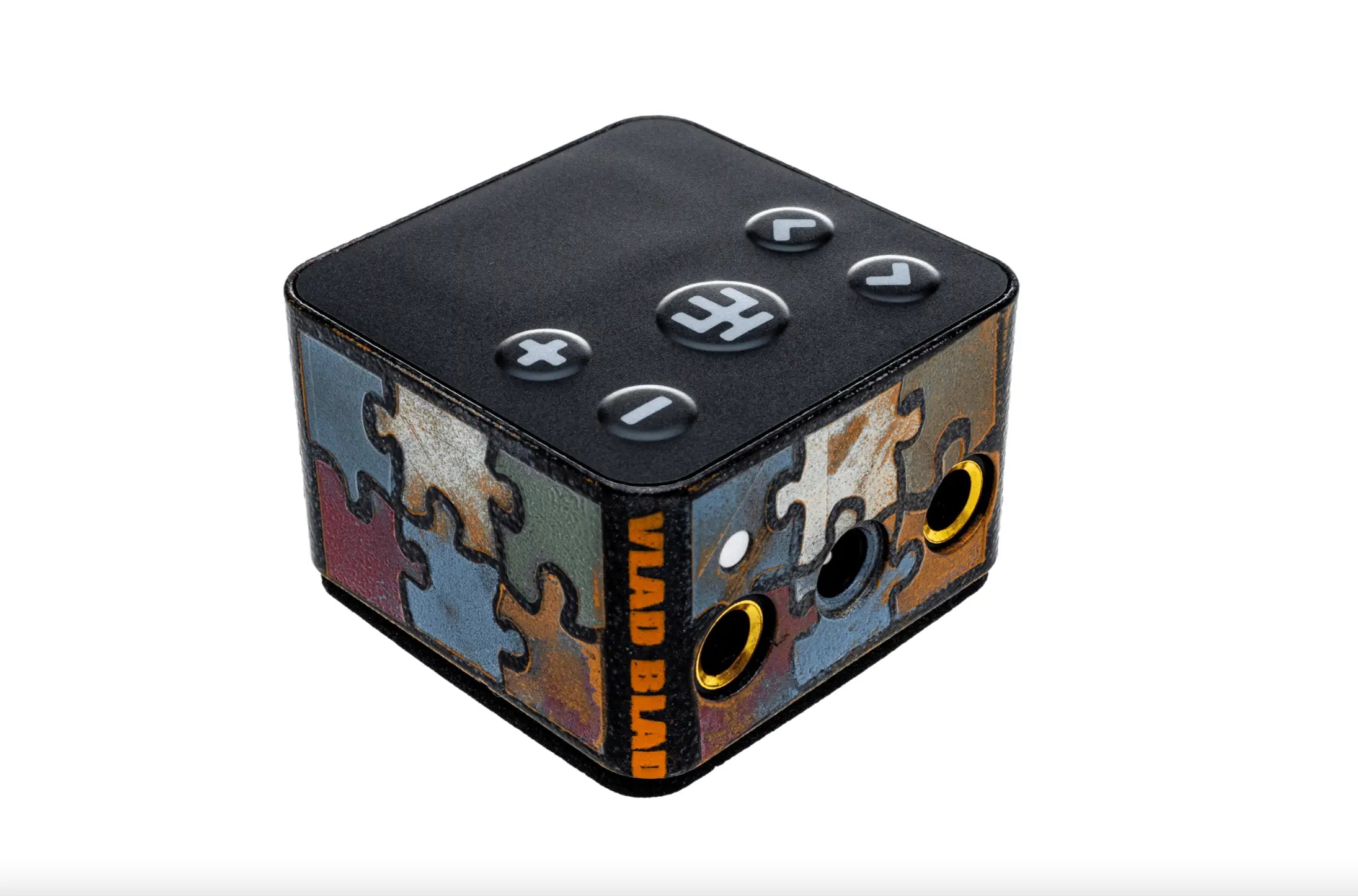 Black cube-shaped vlad blade powerbox 5 pro audio interface with colorful puzzle design and gold 3.5mm jacks