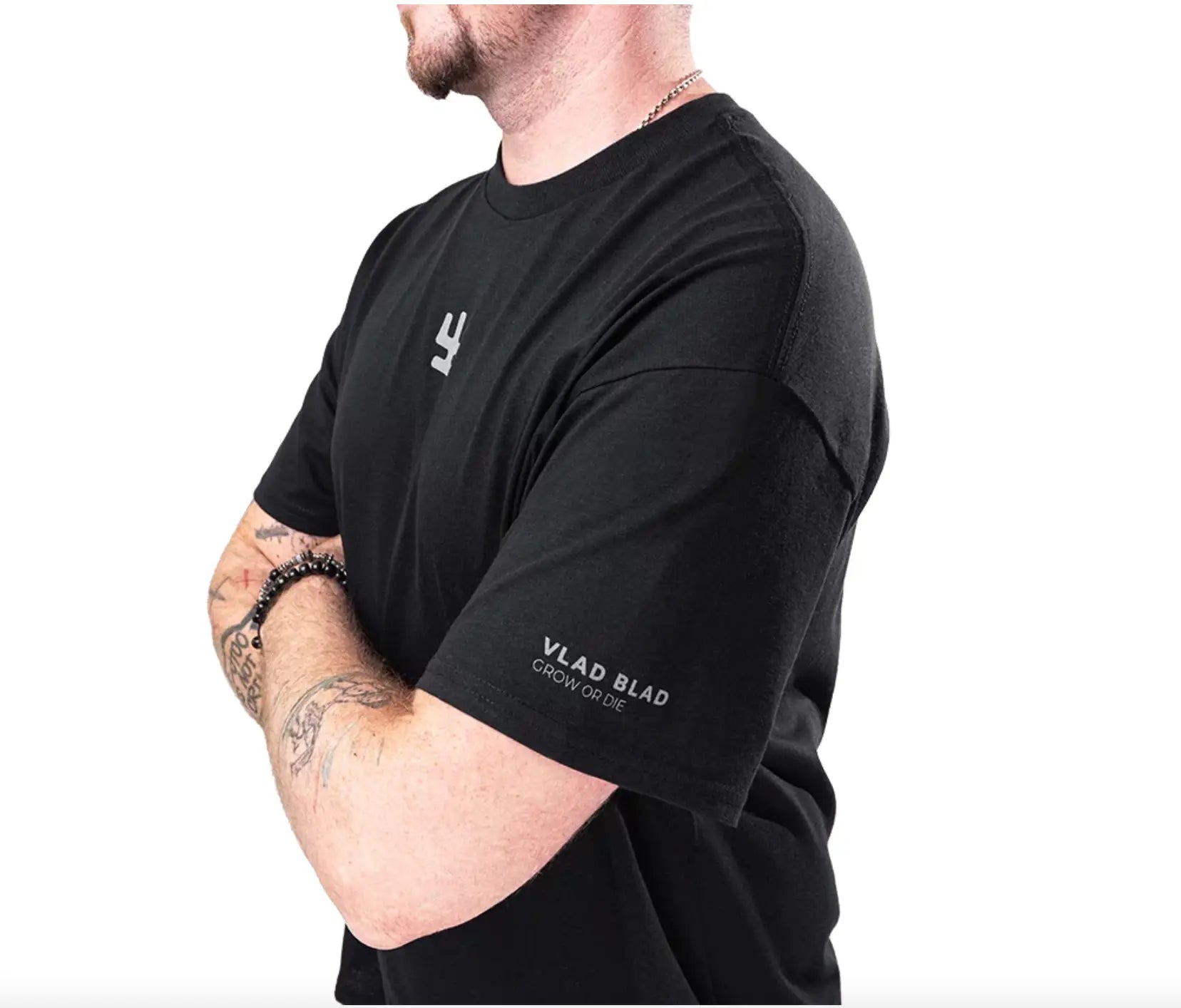 Black short-sleeved vlad blad shirt with subtle gray chest logo and white grow or die print on the sleeve