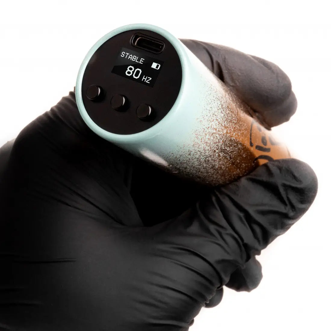 A sleek tattoo machine VLAD BLAD Ultron 4 with mint to bronze gradient finish and black display showing stable 80 hz