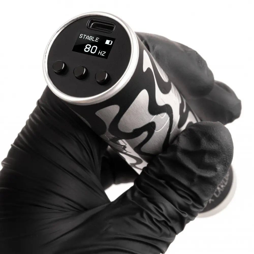 Black and silver tattoo machine vlad blad ultron 4 by carlos magone with digital display showing stable 80 hz and control buttons