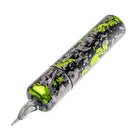 A sleek cylindrical tattoo machine vlad blad ultron 4 in black and neon green splatter paint camo grey green design