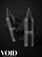 Zwei elegante schwarze Plastikflaschen mit Farben für Void-Tattootinte, minimalistischem weißem Branding und schwarzen Schraubkappen für schwarze Tattoo-Pigmentstruktur
