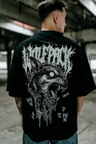 Black oversized unisex short-sleeved cotton tee with white snarling wolf graphic and wolfpack text design