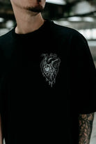Black oversized unisex WOLFPACK Abyss Hound tee with detailed white anatomical heart illustration and dripping effects