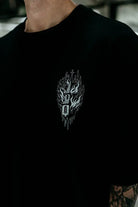 Black crewneck cotton tee featuring white embroidered church graphic with flames and dripping effects unisex oversized