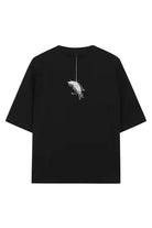 Back of black oversized tee unisex with white bird line-art hanging from string wears size shown