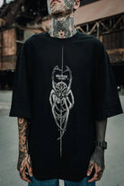 Black oversized tee unisex featuring a white line-art spider graphic with wolfpack text above it wears size standard