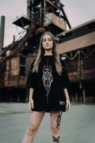 Black oversized tee unisex with white spider graphic and wildfire text from wolfpack connection collection wears size unisex