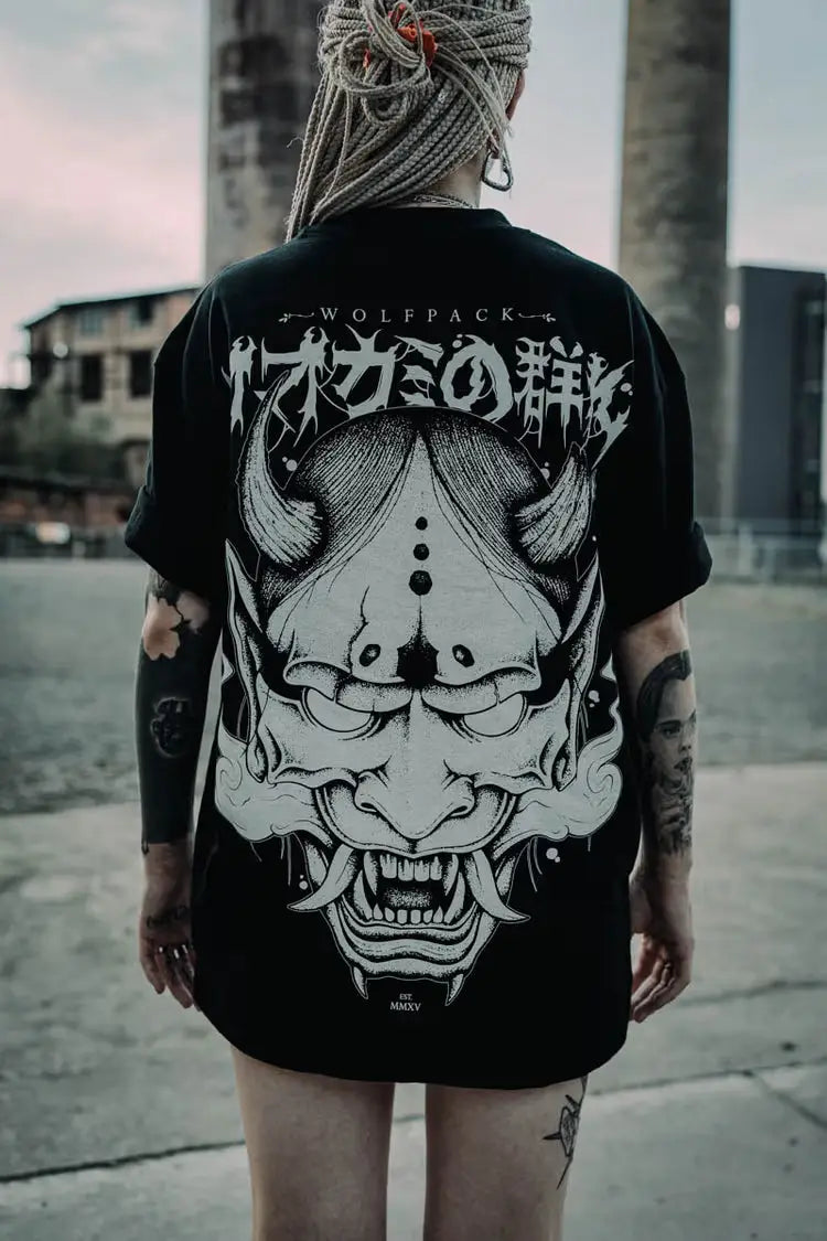 Black oversized tee unisex with white ornate horned demon mask graphic and stylized japanese characters on front