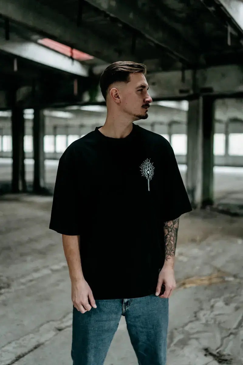 Black short-sleeved cotton wolfpack hell within oversized tee with white intricate tree graphic on left chest unisex