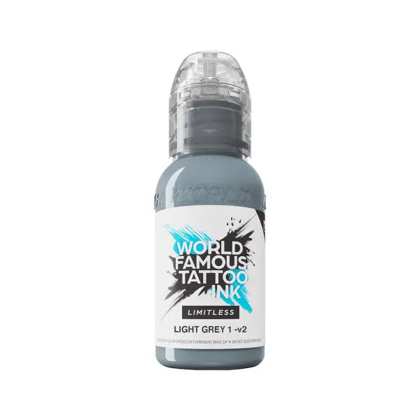A sleek transparent bottle of world famous limitless tattoo ink in light grey with a black and blue label